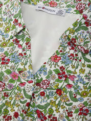 Floral patterned shirt with a visible brand tag on a white background