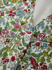 Close-up of a floral-patterned fabric with a button detail.