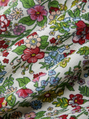 Close-up of floral fabric with colorful flowers on a white background