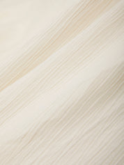 Close-up of a textured fabric with diagonal stripes in beige and white.