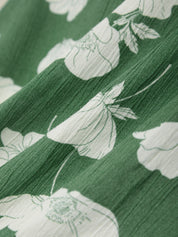 Close-up of green fabric with white floral pattern