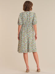 Woman wearing a floral dress on a beige background