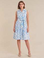 Woman wearing a light blue floral dress on a beige background