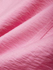 Close-up of pink fabric with a textured pattern