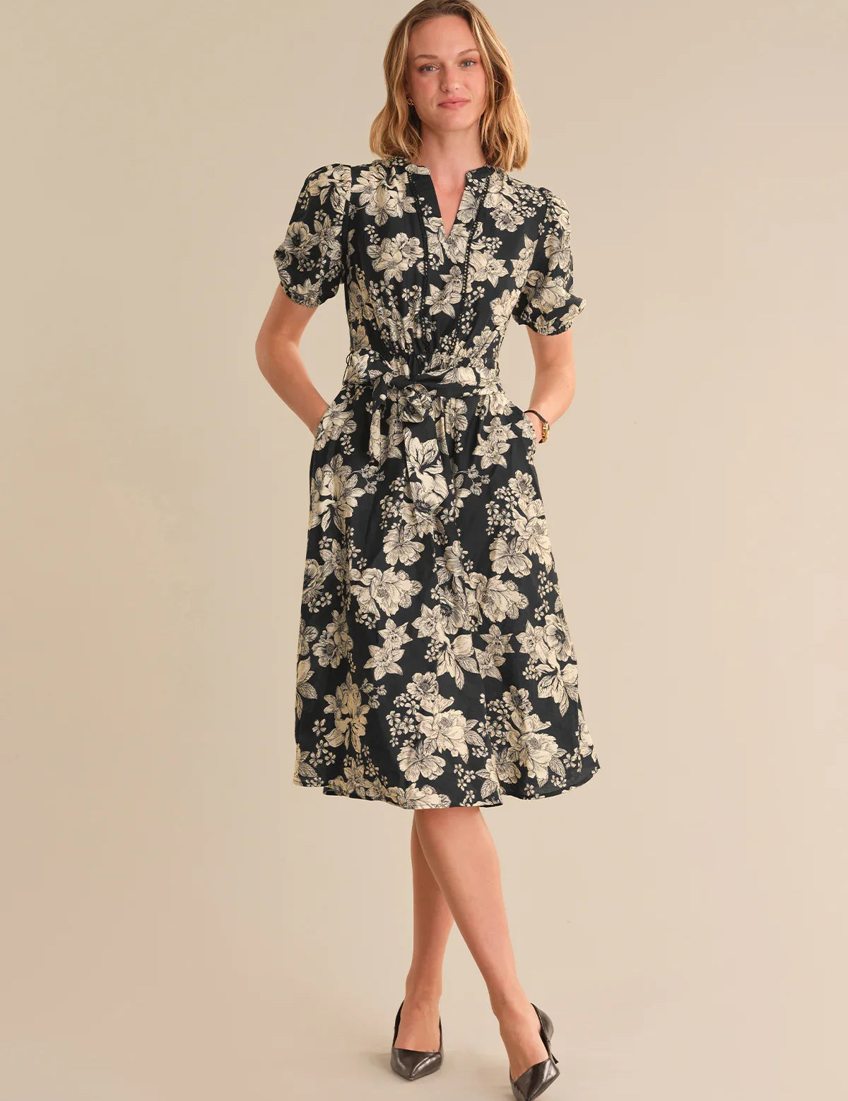 Woman wearing a floral dress on a beige background