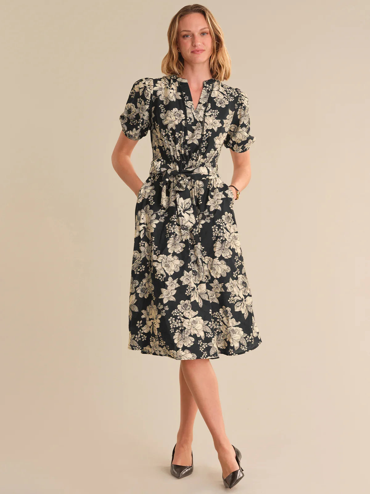 Woman wearing a floral dress on a beige background
