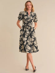 Woman wearing a floral dress on a beige background
