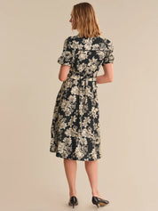 Woman wearing a floral dress on a beige background
