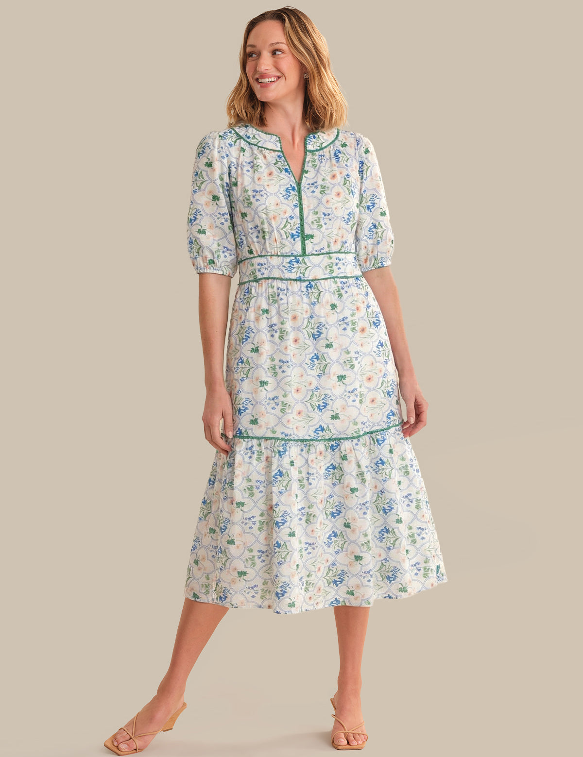 Woman wearing a floral dress on a plain background