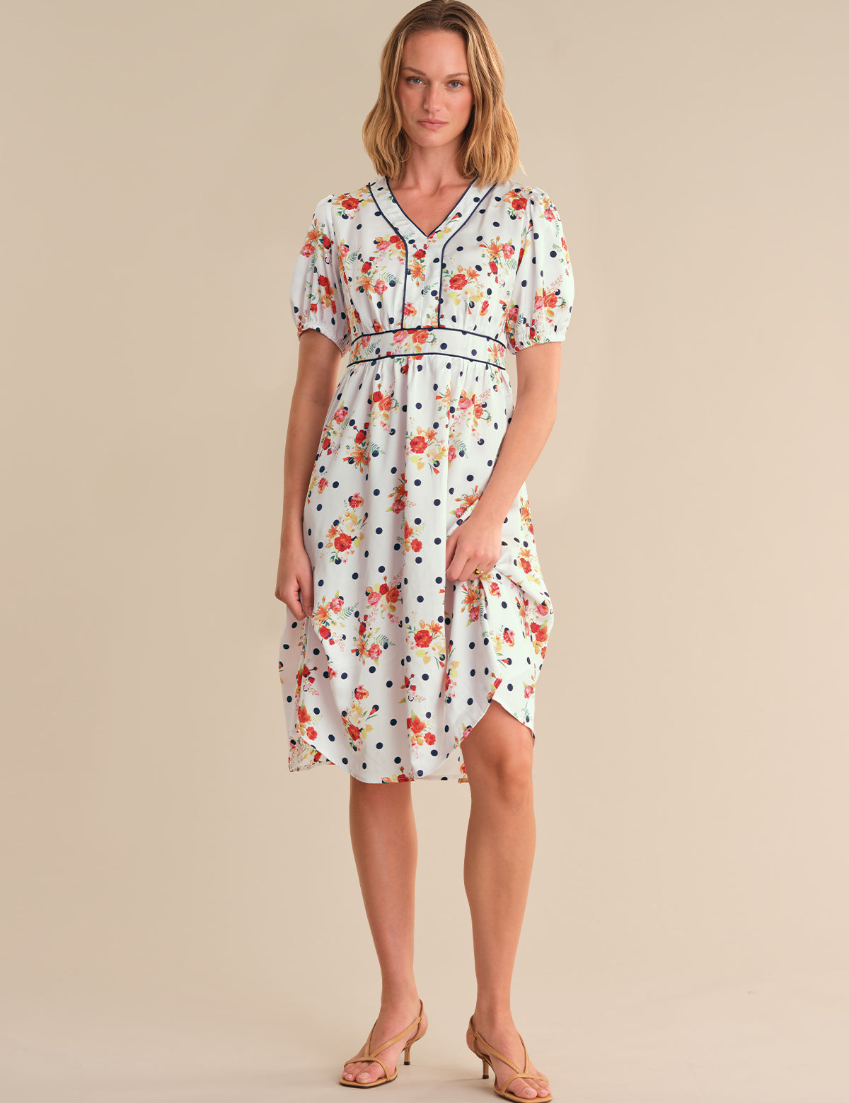 Woman wearing a floral dress on a beige background