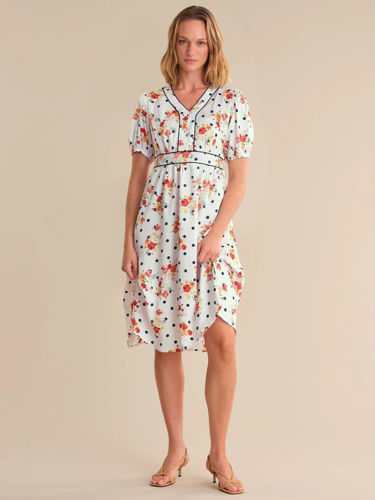 Woman wearing a floral dress on a beige background