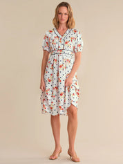 Woman wearing a floral dress on a beige background