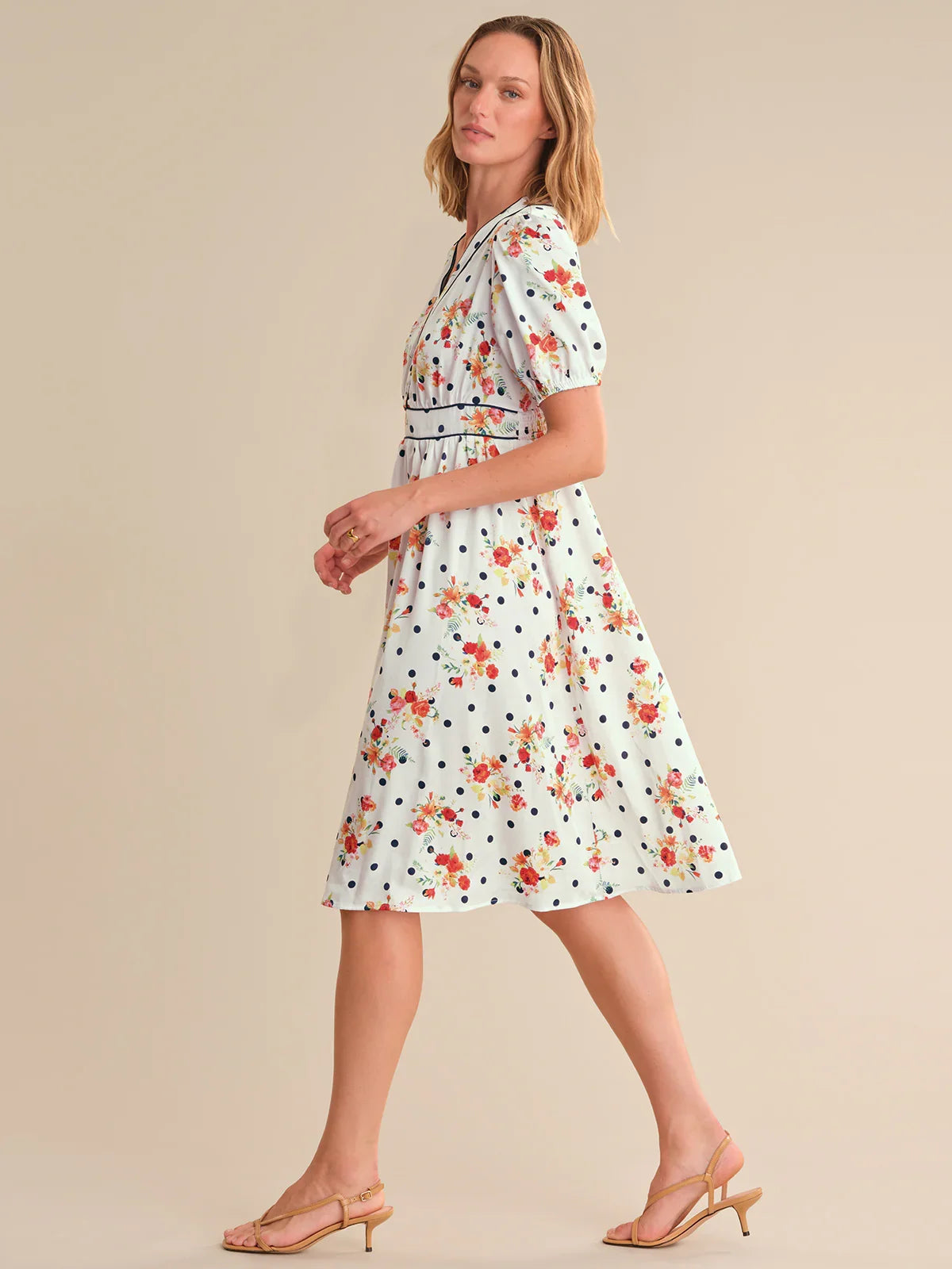 Woman wearing a floral dress on a beige background