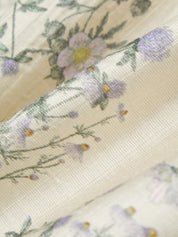 Close-up of floral fabric with a soft focus on a light background