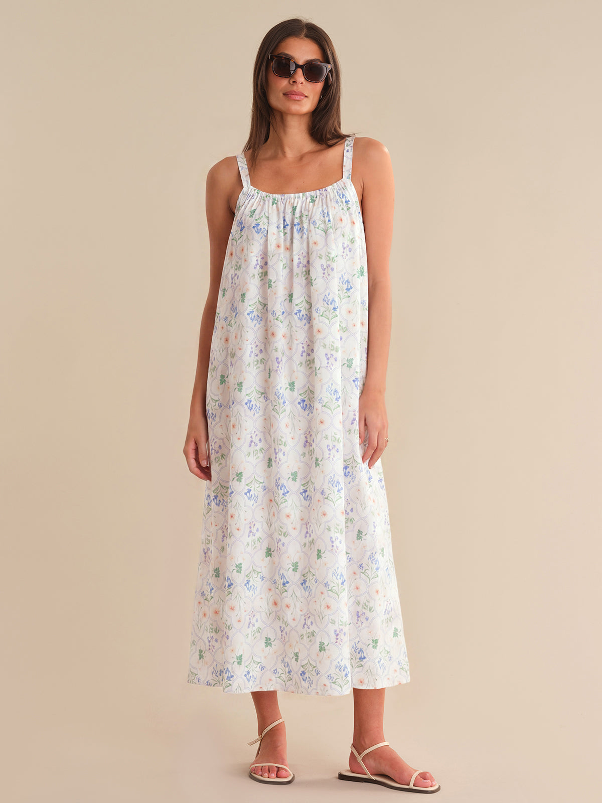 Woman wearing a floral dress against a beige background
