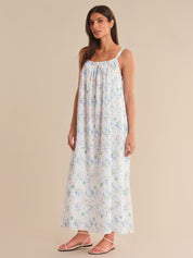 Woman wearing a floral dress on a beige background