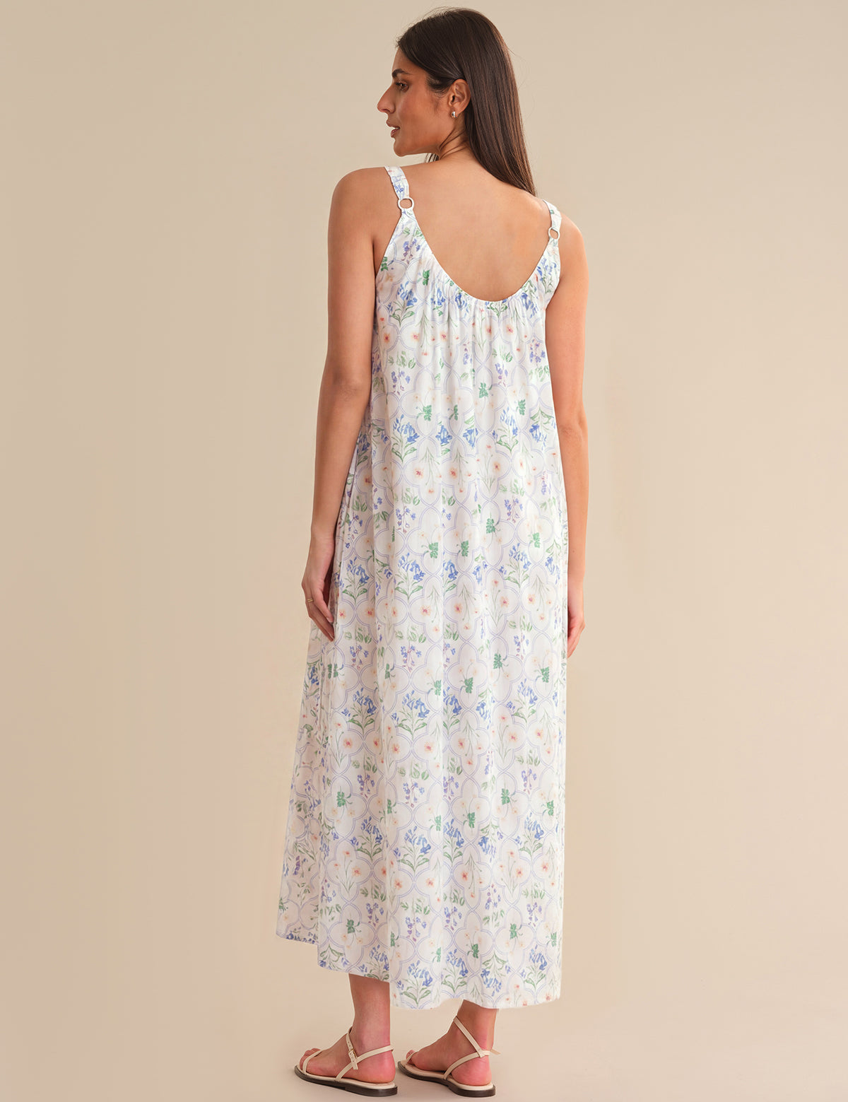 Woman wearing a floral dress on a beige background