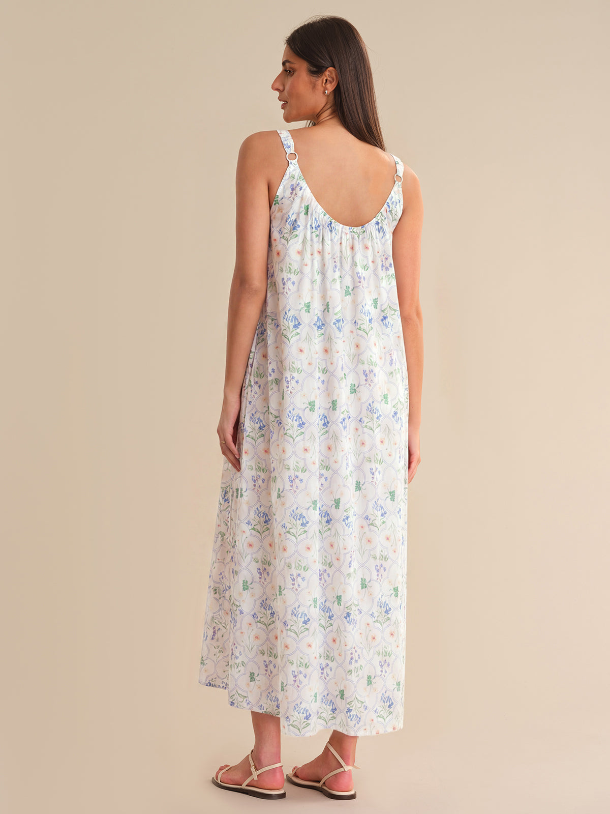 Woman wearing a floral dress on a beige background