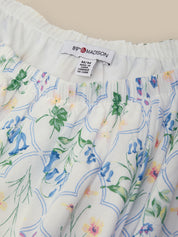 Floral-patterned fabric with a visible brand label on a beige background