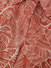 Close-up of a red shirt with white leaf pattern