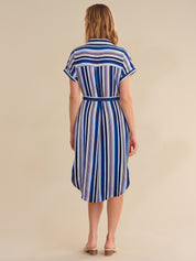 Woman wearing a blue and white striped dress on a beige background