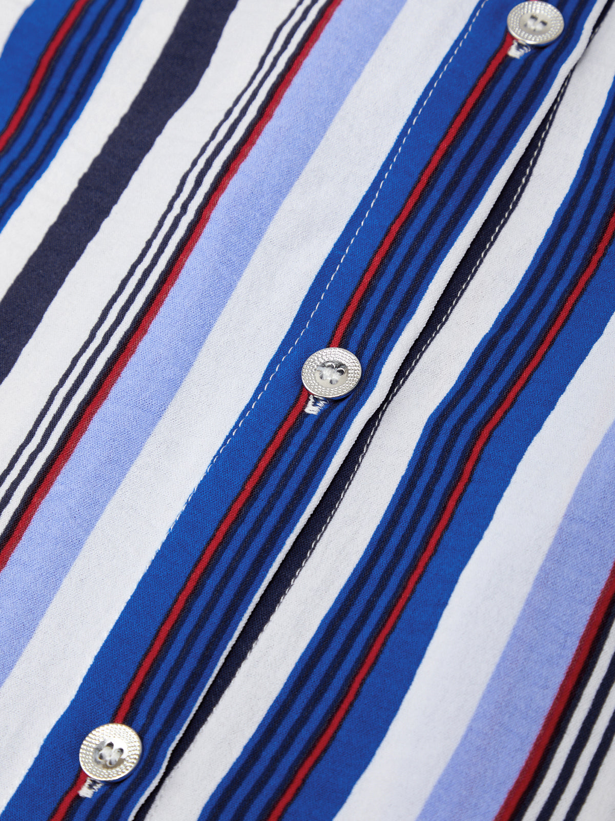 Close-up of a striped shirt with blue, red, and white horizontal stripes and button details.