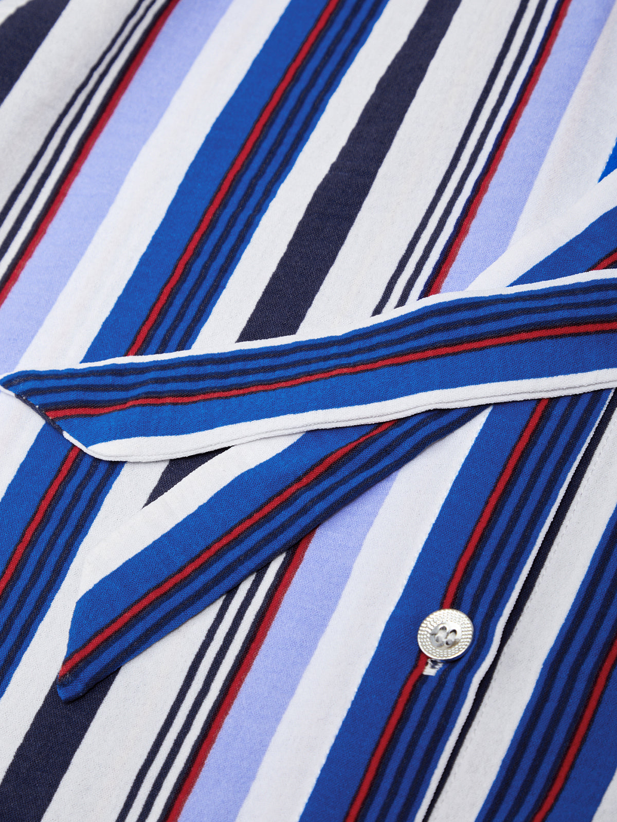 Close-up of a shirt with blue, white, and red vertical stripes.