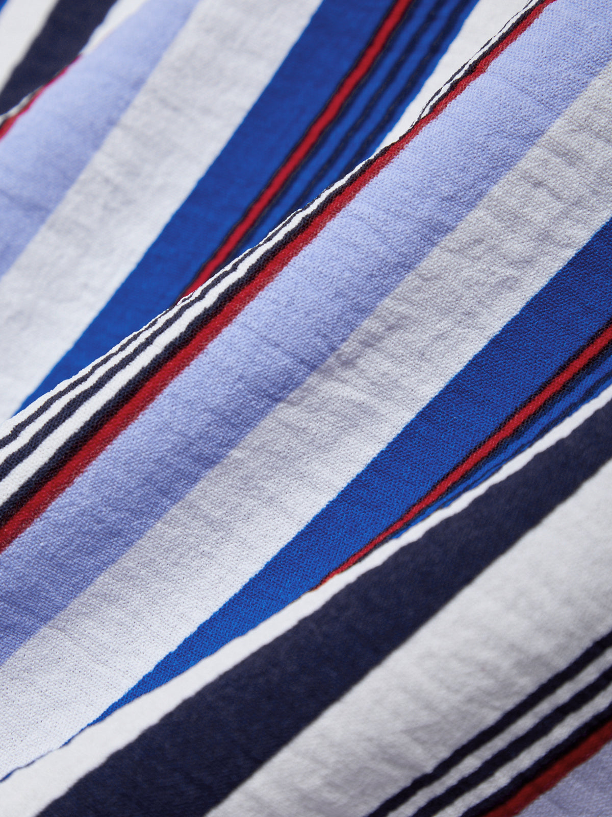 Close-up of fabric with blue, red, and white stripes.