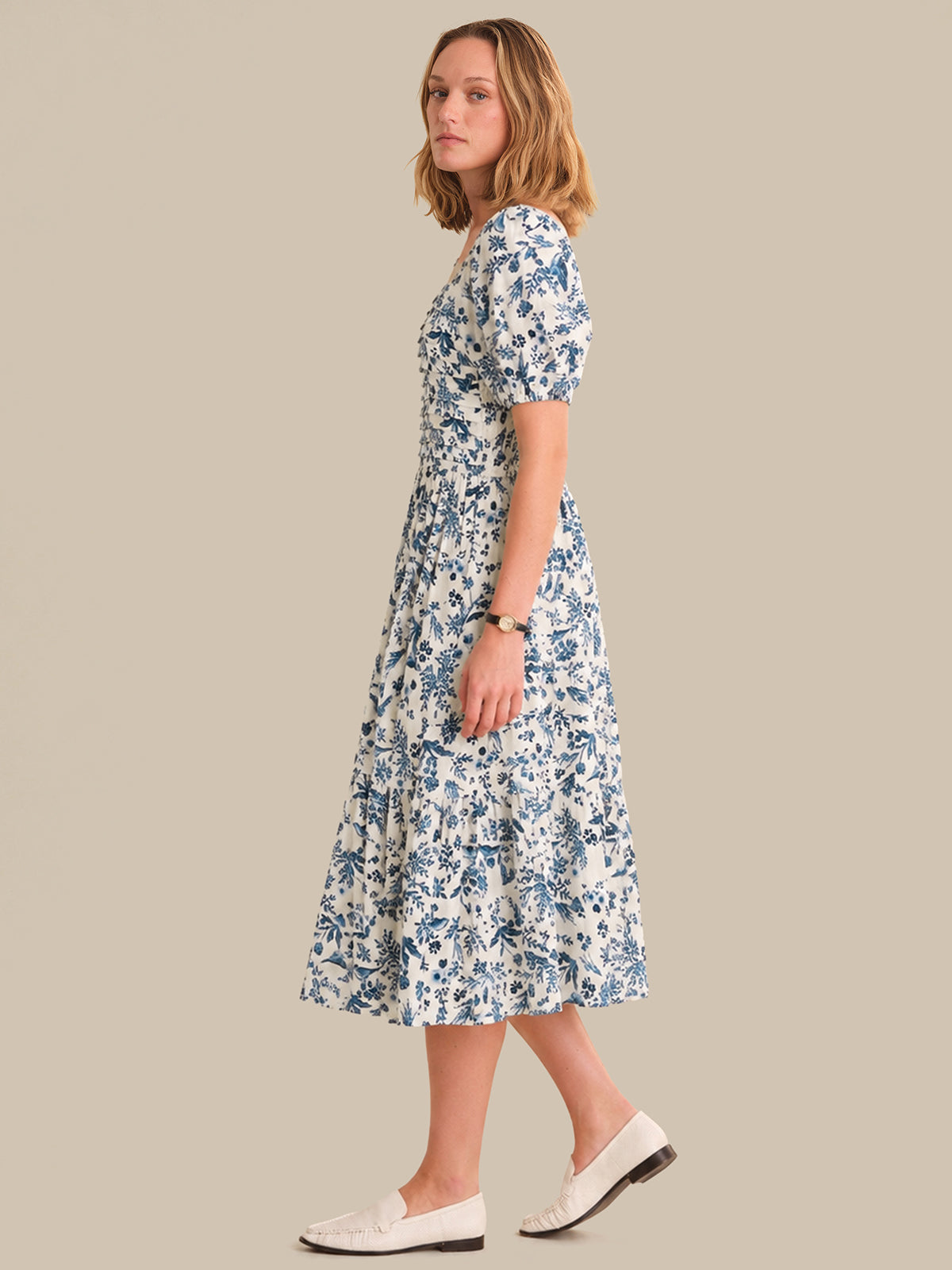 Woman wearing a floral dress on a beige background