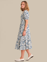 Woman wearing a floral dress on a beige background