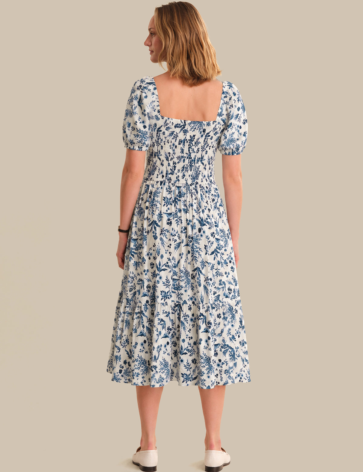 Woman wearing a floral dress on a beige background