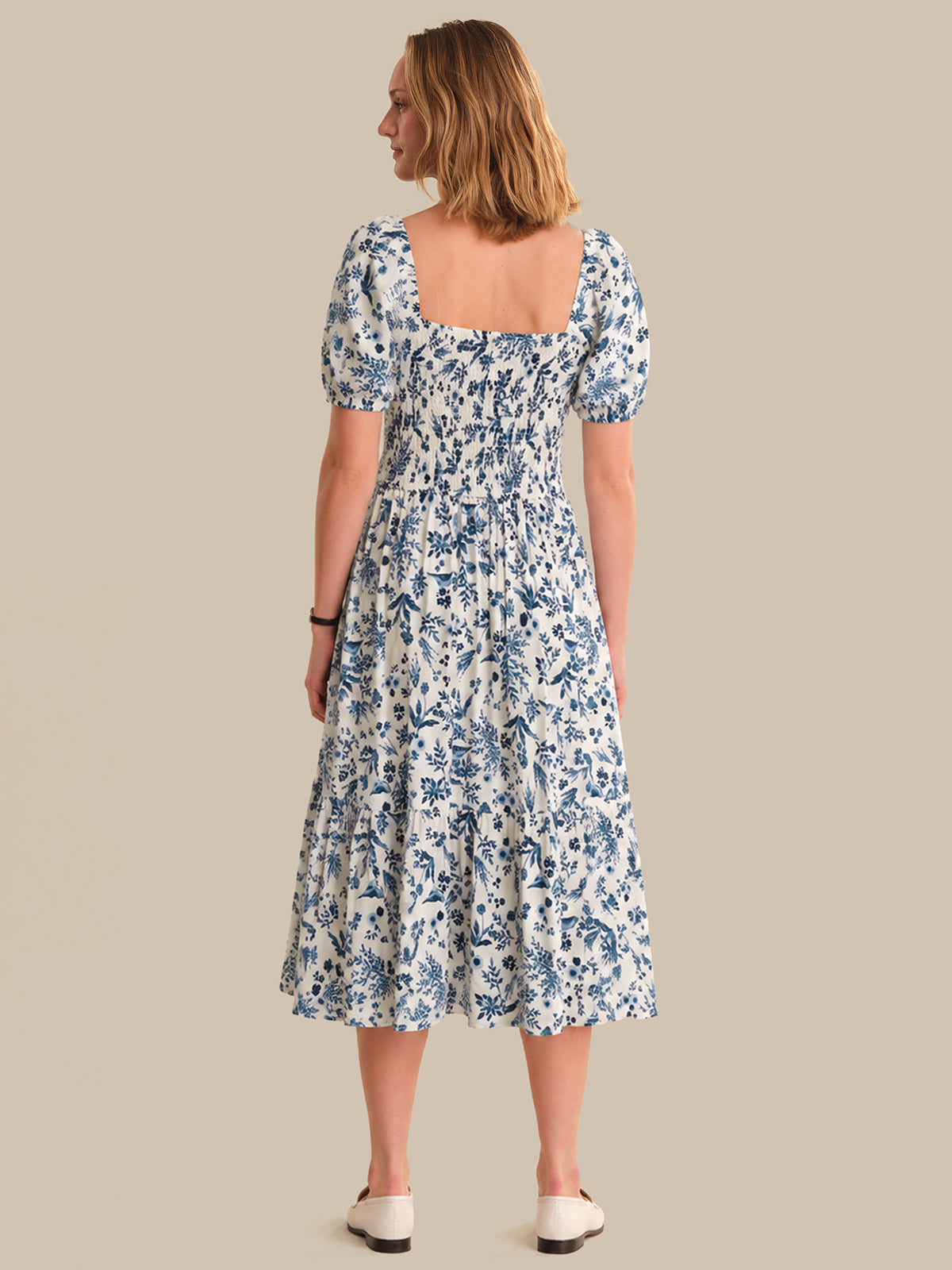 Woman wearing a floral dress on a beige background