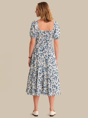Woman wearing a floral dress on a beige background