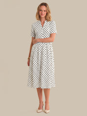 Woman wearing a polka dot dress on a beige background