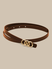 Brown belt with gold rings on a beige background