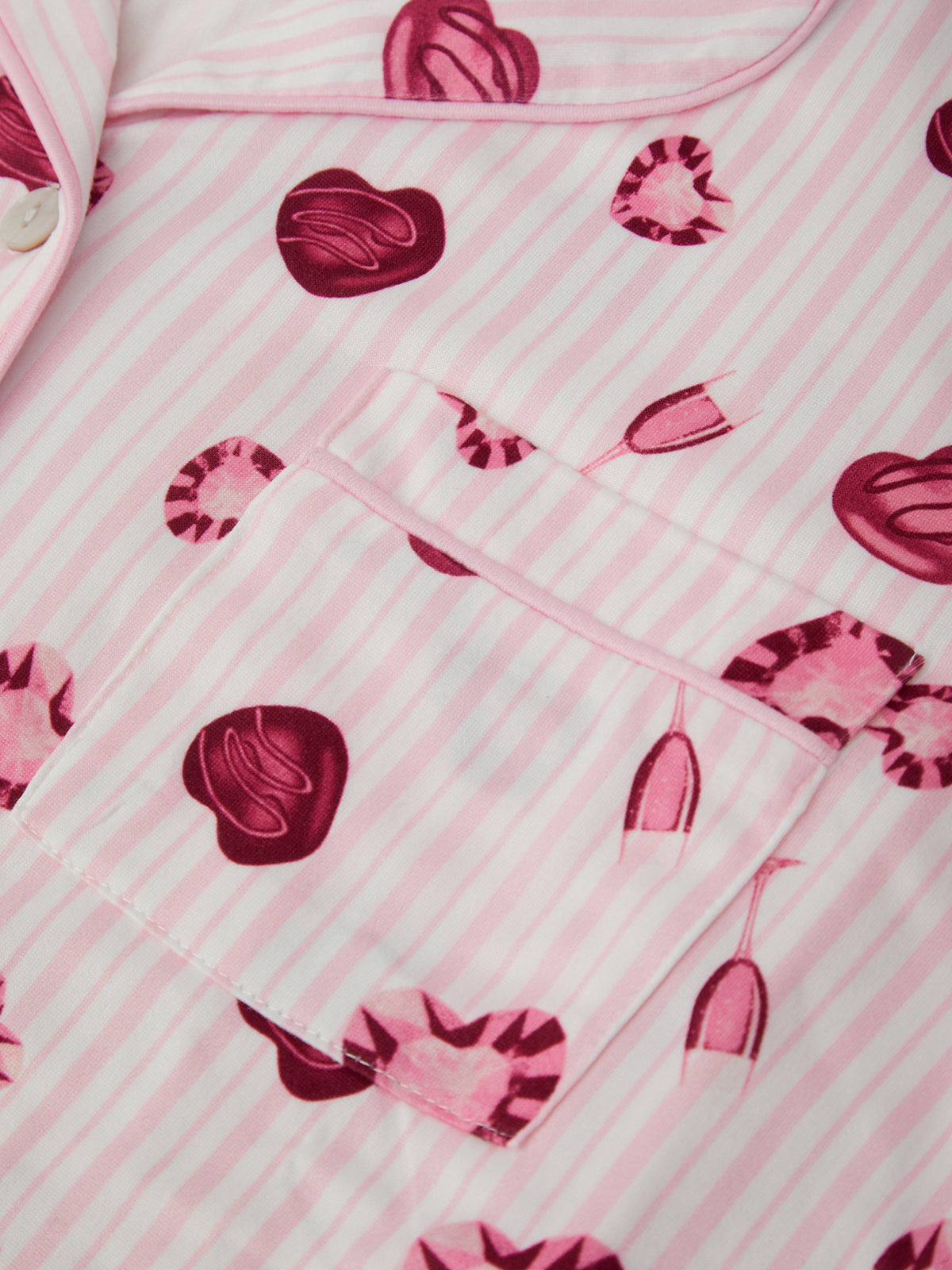 Pink fabric with heart patterns on a striped background