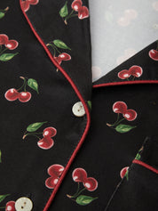 Close-up of a fabric with cherry pattern on a black background