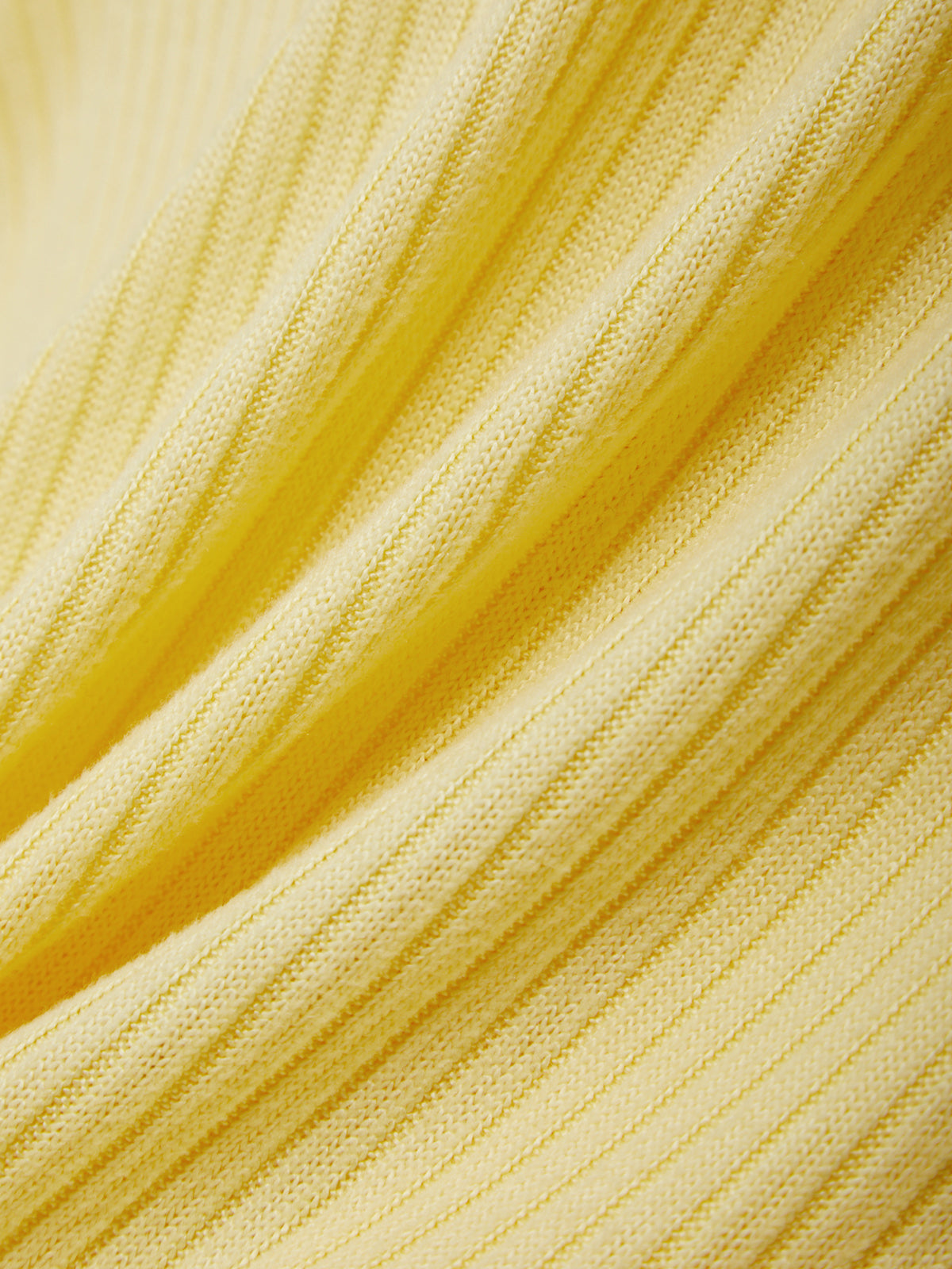 Close-up of yellow fabric with a textured pattern