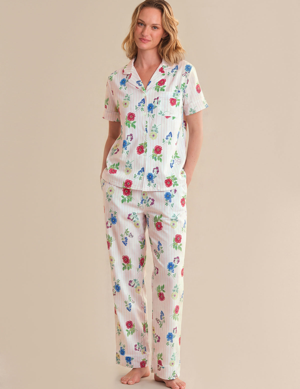 Woman wearing a floral pajama set on a beige background