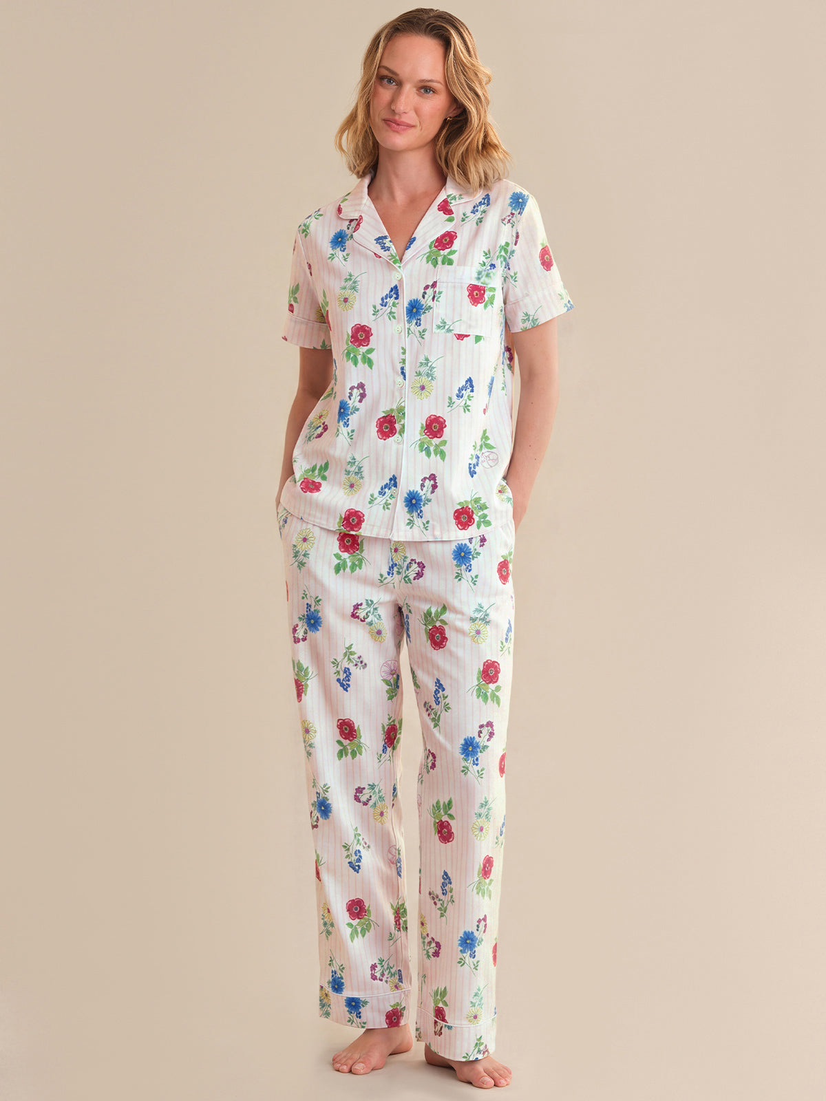 Woman wearing a floral pajama set on a beige background
