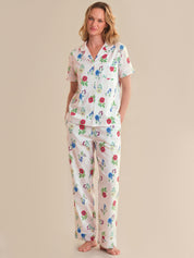 Woman wearing a floral pajama set on a beige background