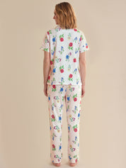 Woman wearing a floral pajama set on a beige background