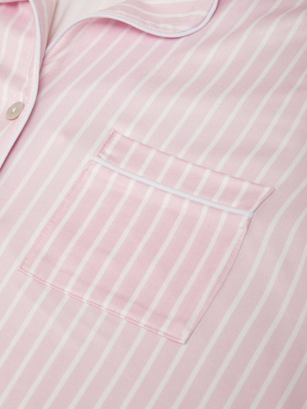 Close-up of a pink and white striped shirt with a pocket.