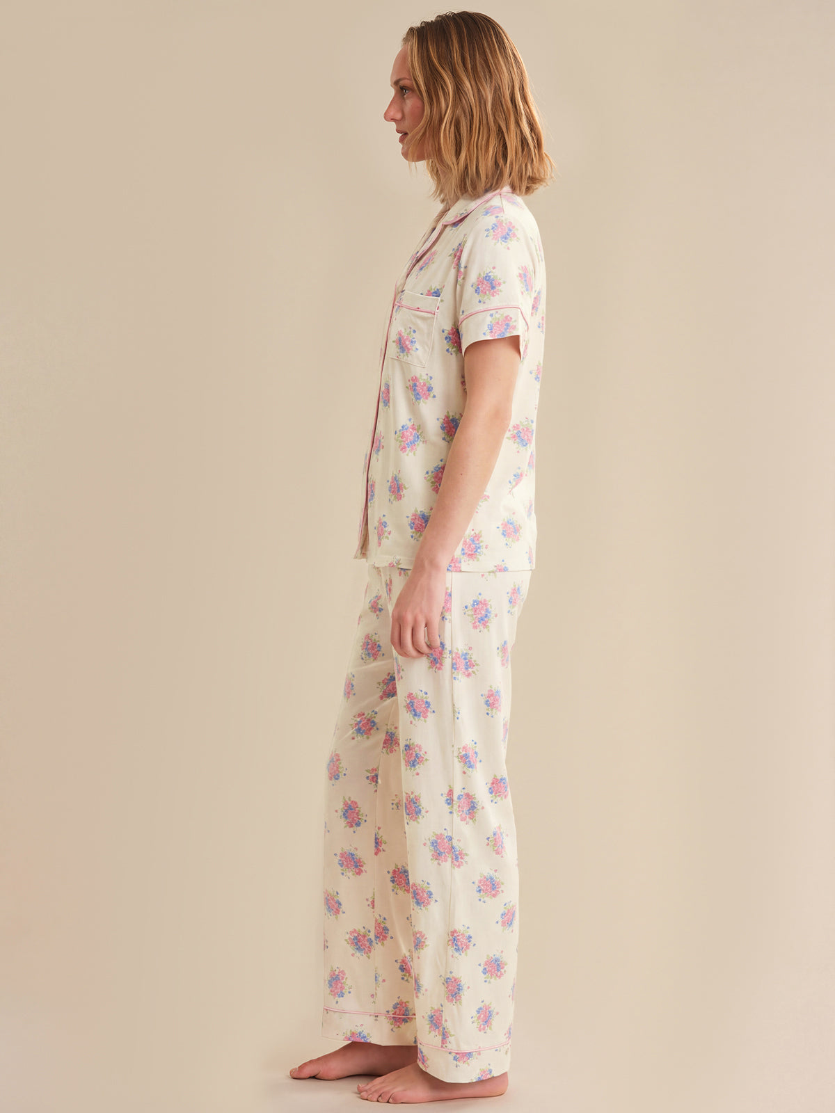 Woman wearing a floral nightgown on a beige background