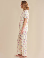 Woman wearing a floral nightgown on a beige background