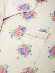 Floral-patterned fabric with a pink zipper pocket on a light background