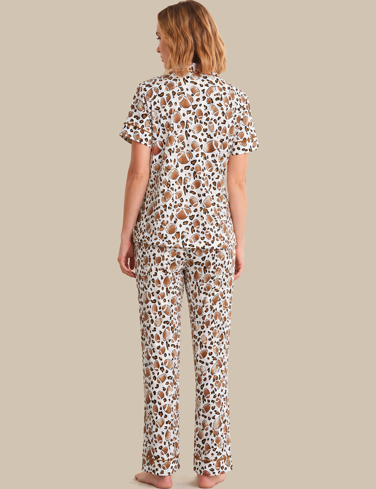 Woman wearing a patterned pajama set on a beige background
