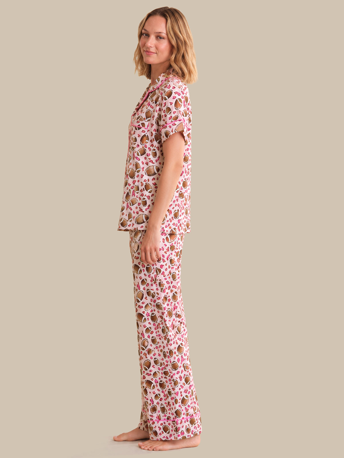 Woman wearing a floral pajama set on a beige background