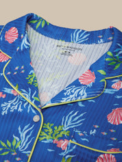 Close-up of a blue shirt with marine-themed design and '89th Madison' label.