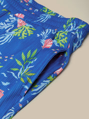 Blue boxer briefs with a colorful tropical sea pattern on a beige background
